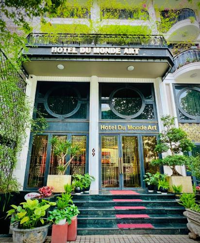 a hotel entrance with plants in front of it at Hotel du Monde Art in Hanoi