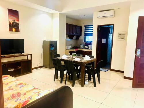 a living room with a dining room table with chairs at Verjandel Residences in Manila
