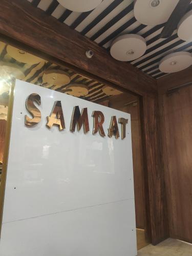 a sign that says samedart on a wall at Hotel Samrat in Gurgaon
