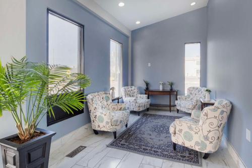 a blue room with chairs and a potted plant at Quality Inn & Suites Bloomington University Area in Bloomington