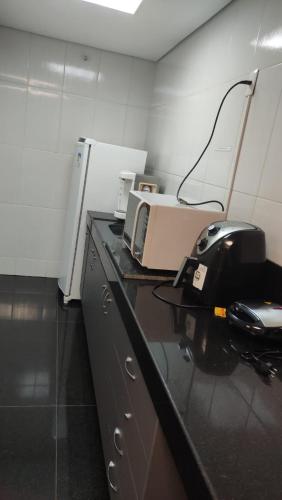 a office with a counter with a phone on it at Hostel Eldorado Contagem in Contagem