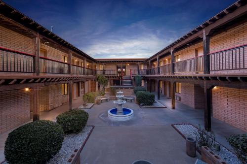 a courtyard with a fountain in the middle of a building at Clarion Inn in Sierra Vista
