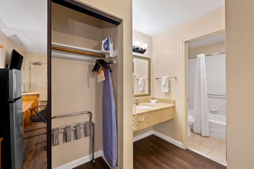 a room with a bathroom with a sink and a toilet at Clarion Inn in Sierra Vista