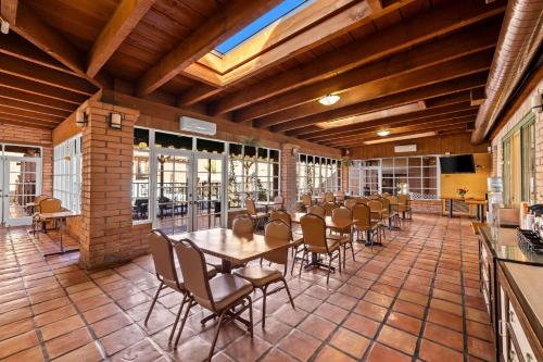 a dining room with a table and chairs at Clarion Inn in Sierra Vista