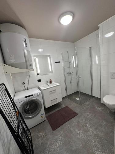 a bathroom with a washing machine and a sink at Central apartment from 2025 in Alta