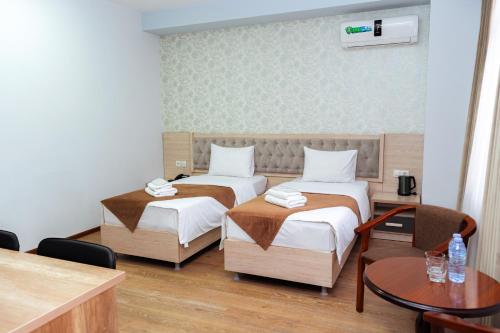 Кровать или кровати в номере Diamond Hotel Tashkent