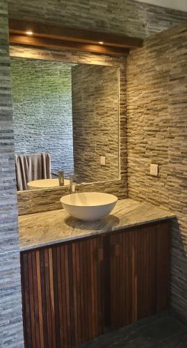 a bathroom with two sinks and a large mirror at RésidenceSuisse Roof-Top in Nosy Be