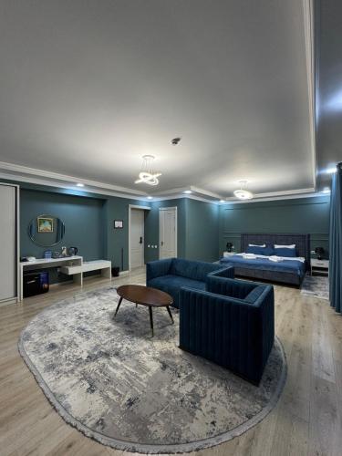 a living room with a couch and a bed at CITIZEN HOTEL in Nukus