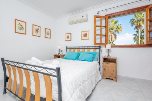 a white bedroom with a bed and a window at Casa Judith in Muro