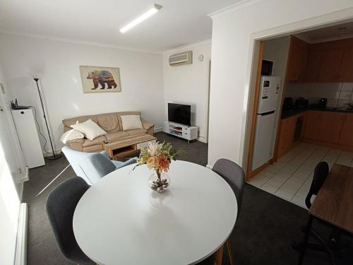 a living room with a table and a couch at Cute, Cosy and Central Apartment 1 in Essendon with Free Parking in Melbourne