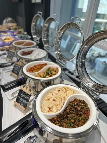 a buffet filled with plates of food on a table at Al Diar Sawa Hotel Apartments in Abu Dhabi