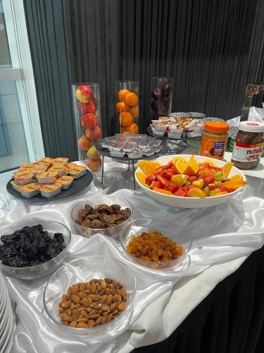 a table with many plates of food on it at Al Diar Sawa Hotel Apartments in Abu Dhabi