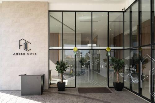 an entrance to an office building with glass doors at Amber Cove Melaka in Melaka