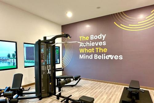 a fitness room with a gym with a sign on the wall at Amber Cove Melaka in Melaka