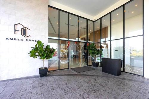 a lobby of an office building with potted plants at Amber Cove Melaka in Melaka