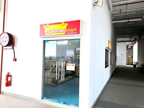 a store with a sign on the door of a store at Amber Cove Melaka in Melaka