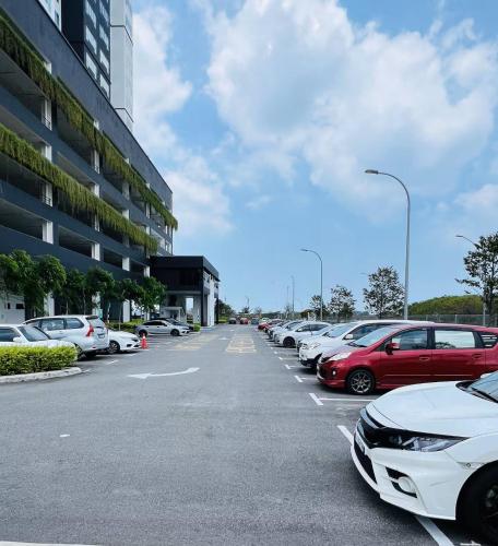 a parking lot with a bunch of cars parked at Amber Cove Melaka in Melaka