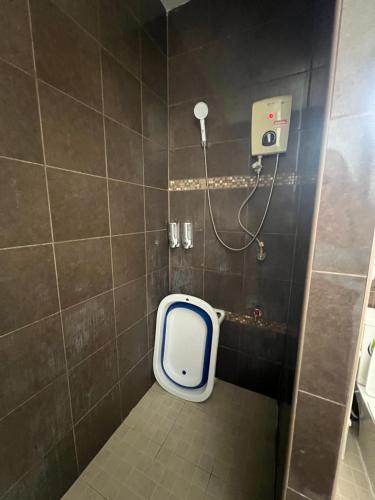a bathroom with a shower with a toilet in it at BN Villa Walk to Bangtao Beach Near Markets in Phuket