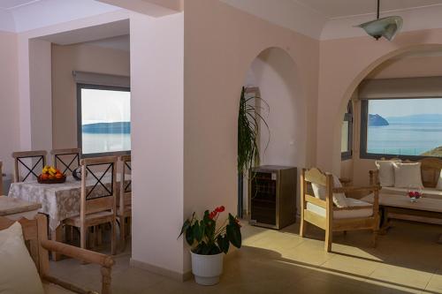 a living room with a view of the ocean at Our Villa Santorini in Akrotiri