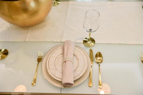 a table with a plate with a napkin and fork and knife at Villa Dolce Vita in Međugorje