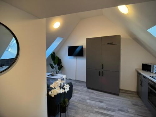 a kitchen with a refrigerator in the corner of a room at ARYVE Boutique-Apartments in bester Lage in Bad Hersfeld in Bad Hersfeld
