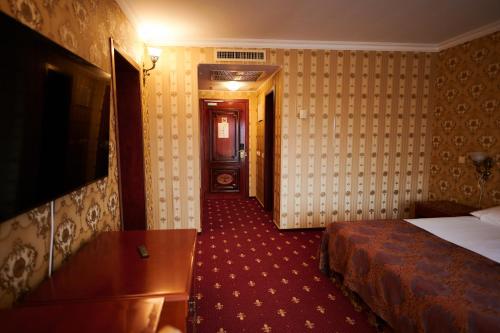 a hotel room with a bed and a hallway at Hotel La Castel Iasi in Iaşi