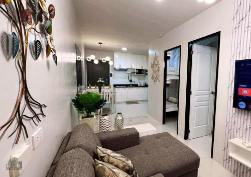 a living room with a couch and a kitchen at Luxury Stay with Balcony, Free Gym & Pool in Bancao-Bancao - B2 6Luster in Puerto Princesa City