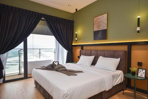 a bedroom with a large bed and a large window at Country Garden Seaview Suite by Nest Home at Danga Bay in Johor Bahru