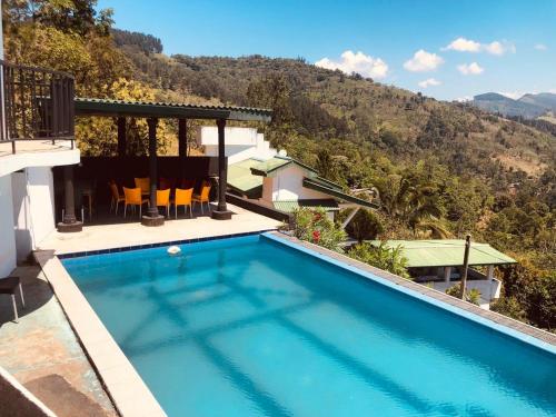 a swimming pool with a view of a mountain at Jc MOUNT EDGE VILLA in Doluwa