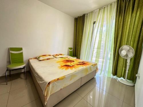 a bedroom with a bed and a window with a fan at Tempo Sea Suits in Kérynia