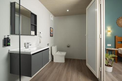 a bathroom with a sink and a toilet at Royal Touch Beach Huts in Palolem