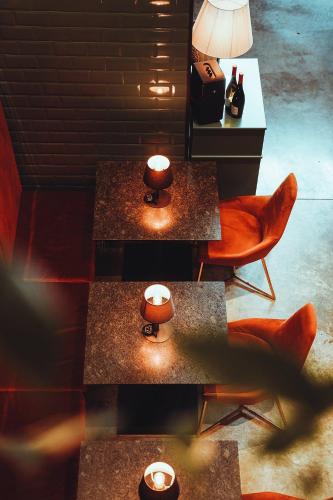 a room with two tables and chairs and a lamp at Infinity Tower apartments Batumi in Batumi