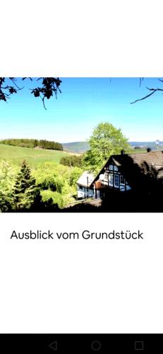 a picture of a house in the middle of a field at Ferienwohnung Dörnberg erleben mit Tiere bei Winterberg in Bestwig