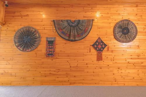 a wall with three hats and a kite on it at Táo Tày House in Sa Pa