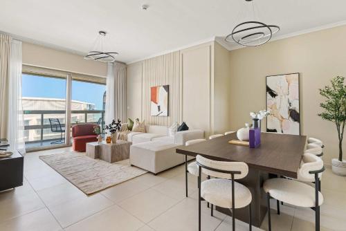 a living room with a table and chairs and a couch at Silkhaus Vacation Homes Luxury 2BDR with Maid Room in Ajwan Towers in Abu Dhabi