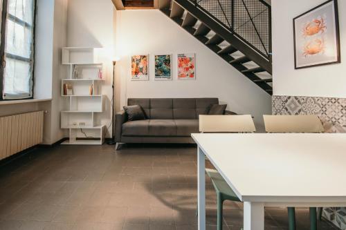 a living room with a couch and a table at Bigattera Apartments in Varese