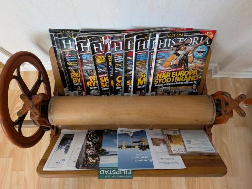 a book rack filled with books and magazines at Charming Family-Friendly Villa in Lesjöfors