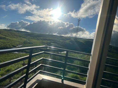 a view of the hills from a balcony of a house at Clouds Lodge in Cherrapunji