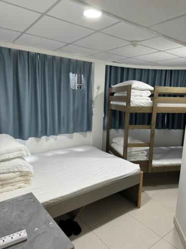 a room with two bunk beds and a ladder at Le Cong Fraternal Guest House in Hong Kong