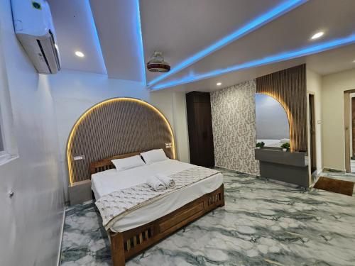 a bedroom with a bed and a tv on a wall at Nandi Homestay Hampi in New Hampi