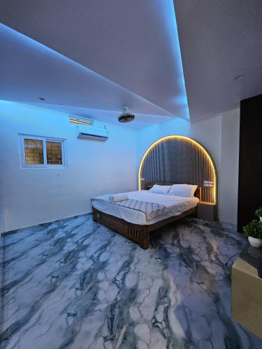 a bedroom with a bed with a marble floor at Nandi Homestay Hampi in New Hampi