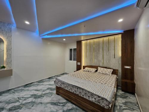 a bedroom with a bed and a blue light at Nandi Homestay Hampi in New Hampi