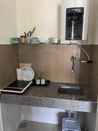 a kitchen counter with a sink and a microwave at 1 bed peaceful studio Apartment near Colva beach in Benaulim