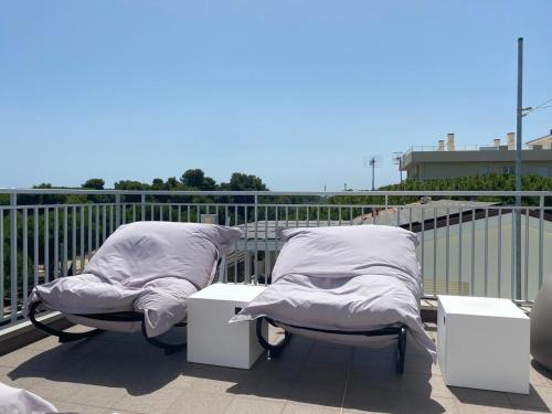 two beds with pillows on a balcony at Hotel Miramare Dipendenza in Pineto