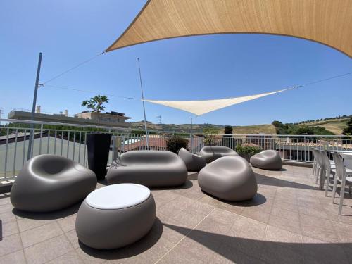 a group of gray objects sitting on a patio at Hotel Miramare Dipendenza in Pineto