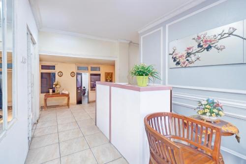 a dining room with a table and a chair at Hotel O Bogor Near Museum Peta in Bogor