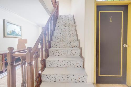 a stairway with a door leading up to a room at Hotel O Bogor Near Museum Peta in Bogor