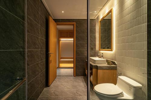 a bathroom with a toilet and a sink at Nam Dat Hotel by D'Lecia Ha Long in Ha Long