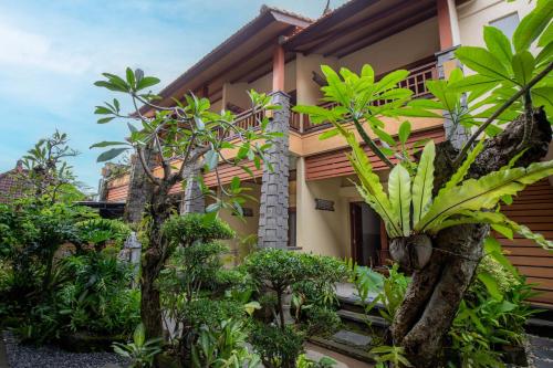 a house with trees and plants in front of it at Donahome in Sanur