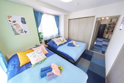a small room with two beds and a hallway at AO201 - 2F Tokyo Stay Hotel Direct Train to Narita & Asakusa in Tokyo